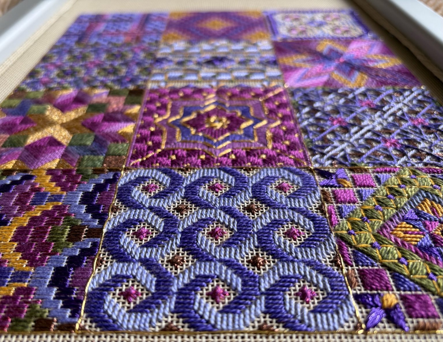 Close-up of The Bazaar Collection showing varied geometric stitches and dimensional thread textures.